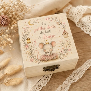 May include: A square wooden keepsake box with a metal latch, featuring a printed illustration of a mouse wearing a crown and tutu, surrounded by floral wreaths, a crescent moon, a lantern, and a birdhouse, with the text Les petites dents de lait de Louise.