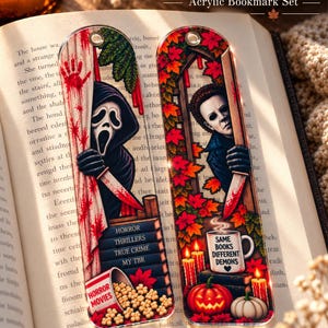 May include: Two rectangular acrylic bookmarks featuring horror movie characters. One shows Ghostface with a bloody knife and a bucket of popcorn labeled Horror Movies. The other shows Michael Myers, autumn leaves, pumpkins, and a mug labeled Same Books Different Demons.