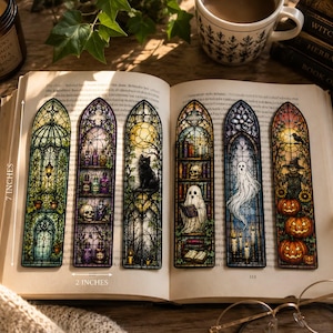 May include: A set of six rectangular bookmarks featuring stained glass window designs, each measuring 7 inches by 2 inches. The illustrations include a greenhouse, potion bottles, a black cat, ghosts, books, and pumpkins, all framed in gothic arches.