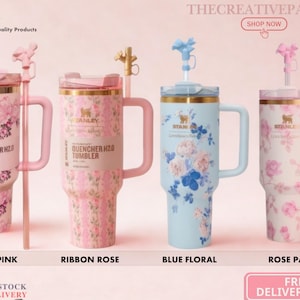 May include: Four Stanley Quencher H2.0 tumblers with handles and straws. The first is pink with floral patterns, the second is pink with ribbon rose designs, the third is light blue with floral prints, and the fourth is white with rose patterns.
