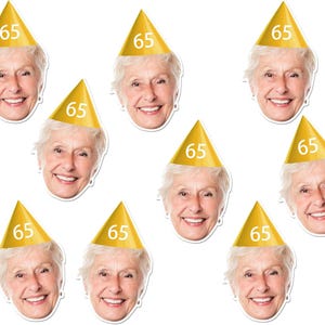 May include: A collection of die-cut face cutouts of a smiling older woman wearing a gold party hat with the number 65 printed on it. The cutouts are arranged against a white background.