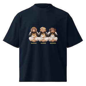 May include: Navy blue t-shirt featuring the three wise monkeys: Hear No Evil, See No Evil, and Speak No Evil. The monkeys are depicted in white robes and gold jewelry. Text below each monkey reads "Hear No Evil", "See No Evil", and "Speak No Evil".