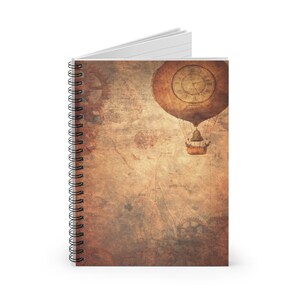 May include: Spiral-bound notebook with a steampunk design. The cover shows a sepia-toned illustration of a hot air balloon with a clock face, set against a backdrop of gears and aged paper textures.