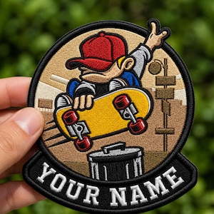 May include: Embroidered patch featuring a cartoon skater in a red cap, riding a yellow skateboard. The patch has a black border with the text "YOUR NAME" in white. The background includes a cityscape and a trash can.