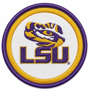 May include: A circular embroidered patch featuring the purple and gold LSU logo with a stylized tiger eye graphic above the letters. The design is set against a white background, enclosed by a thick gold border and an outer purple stitched edge.