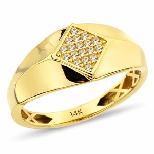 May include: A gold ring featuring a square diamond-shaped setting with small, clear gemstones. The ring has a smooth, polished band and a 14K stamp. The ring is a bright, shiny gold colour.