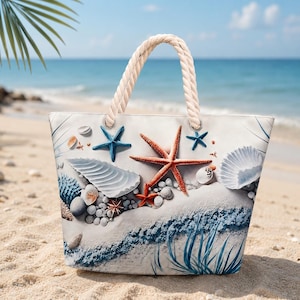 May include: A tote bag featuring a beach-themed print with a large orange starfish, a blue starfish, various white seashells, and smooth pebbles on a sandy background. The bag has two thick, cream-colored twisted rope handles attached with metal grommets.