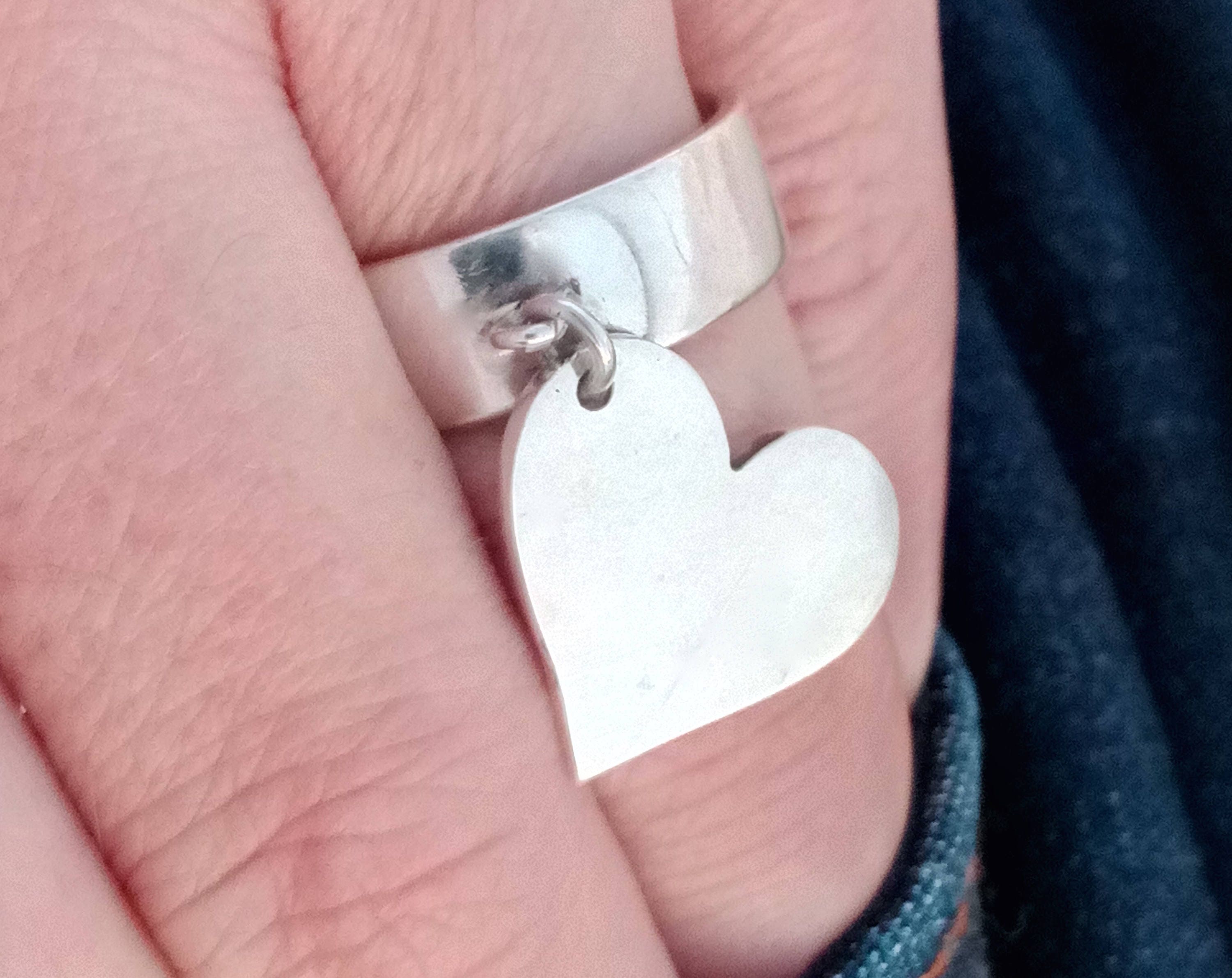 Silver ring with dangling on sale heart