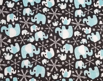 May include: A black fabric with a repeating pattern of blue elephants and white snowflakes. The elephants have white outlines and the snowflakes have six points.