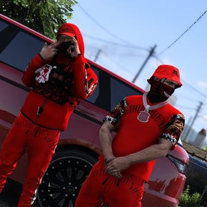 May include: Two figures wearing matching bright red outfits consisting of hoodies, joggers, and bucket hats. One figure wears a black tactical vest over the hoodie. Both wear red face masks and stand in front of a red vehicle with black wheels.