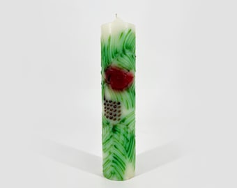 Cardinal candle with pine sprigs and berries