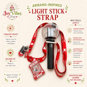 Puede incluir: Correa roja para palos de luz con el texto "ARIRANG-INSPIRED LIGHT STICK STRAP". La correa mide aproximadamente 140 cm de largo y presenta un palo de luz en blanco y negro, un cordón rojo y dijes. La correa está diseñada para conciertos y uso diario.