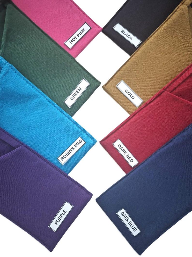 May include: A collection of eight rectangular fabric pouches in various solid colors, each featuring a white rectangular label with black text identifying the color: Hot Pink, Black, Green, Gold, Robins Egg, Dark Red, Purple, and Dark Blue.