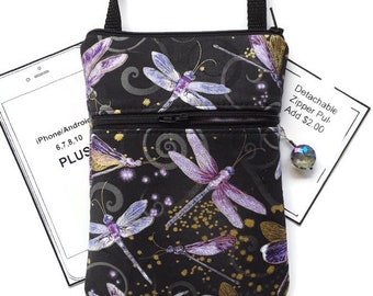May include: Black crossbody bag with a zipper closure and a dragonfly print. The bag has two zippered compartments. The text "Detachable Zipper Pull. Add $2.00" is visible on a white tag.