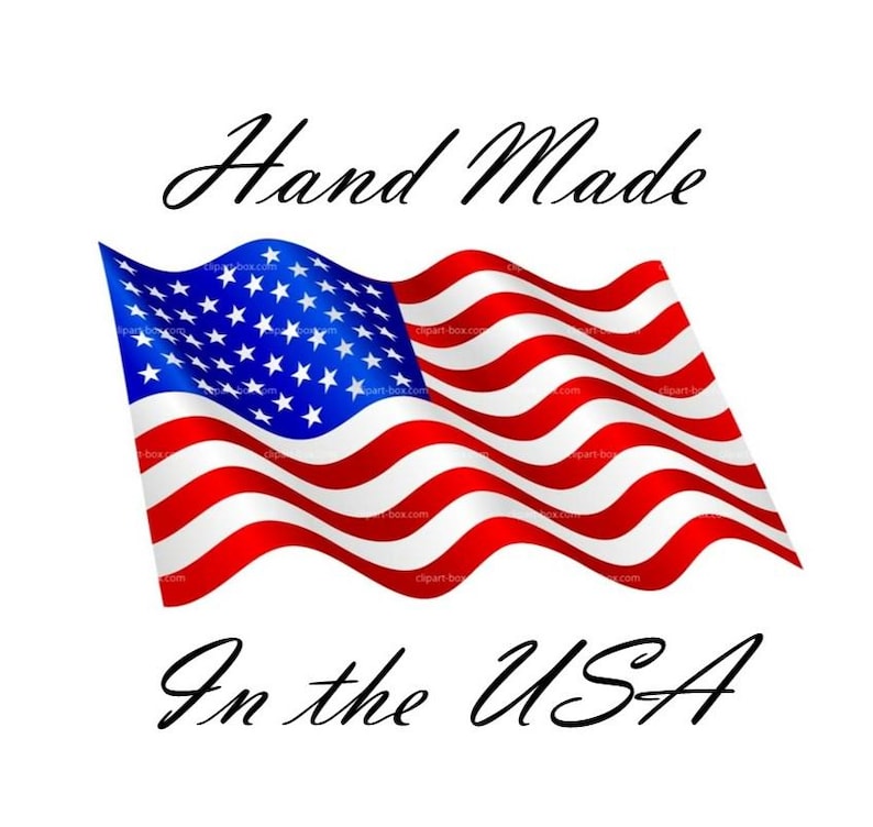 May include: A graphic illustration of a waving American flag featuring red and white horizontal stripes and a blue canton with white stars. The text Hand Made is positioned above the flag, and the text In the USA is positioned below the flag.