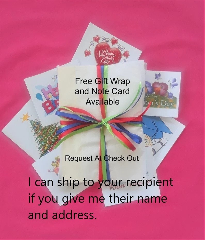 May include: A white rectangular package wrapped with thin red, green, and blue ribbons, surrounded by various greeting cards featuring illustrations of a Christmas tree, a graduation cap, and flowers, with text stating Free Gift Wrap and Note Card Available.