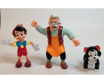 Figura vintage de PVC de Pinocho de Disney acariciando al gato Fígaro, aplaudiendo, de los años 90.