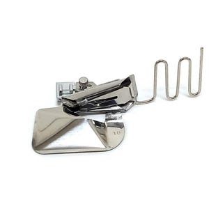 May include: A silver-colored metal sewing machine binder foot attachment featuring a wide, flat base, a folding mechanism, and a thin, wavy wire guide extending from the side. The metal component is clearly stamped with the number 10.