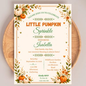 May include: A rectangular invitation card with a cream background featuring orange pumpkins, green leaves, and orange flowers in the corners. The text reads: PLEASE JOIN US TO CELEBRATE LITTLE PUMPKIN Sprinkle HONORING Isabella Tiny hands, tiny feet, our sweetest blessing is almost here! Saturday September 19, 2026 2:00 PM Afternoon Gathering Wildflower Garden Pavilion 246 Blossom Road Nasville Valley Kindly RSVP To Ava At +123-456-789.