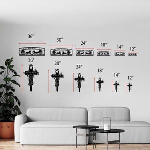 May include: Black metal wall art featuring a Stark Ranch sign with horses and trees, available in various sizes from 12 to 36 inches. Also, black metal crosses with floral and butterfly details, ranging from 12 to 36 inches.