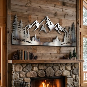 May include: A metal mountain and forest wall art piece. The artwork features a detailed silhouette of a mountain range and trees. It is mounted on a wooden wall above a stone fireplace, creating a rustic, nature-inspired aesthetic.