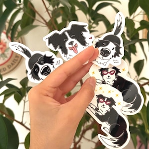 May include: A collection of black and white border collie stickers. Some stickers feature the dog with its tongue out, while others wear sunglasses. The stickers have the text "Sniff Sniff" on them.