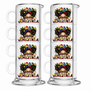May include: Two sets of white stacking coffee mugs with a decorative design. Each mug features a woman's portrait, the word "VENEZUELA", and tropical elements. The mugs are held in a silver metal rack.