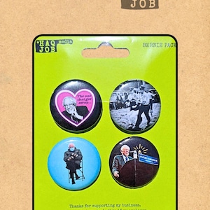 May include: A green card with four round buttons featuring images of Bernie Sanders. The buttons have text and images, including a heart, a photo, and the words "A Future to Believe In." The card also has the text "Thanks for supporting my business."