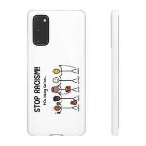 May include: White phone case with the text "STOP RACISM!! It's okay to be..." and stick figures representing different ethnicities. The case has a black camera lens and a side view.