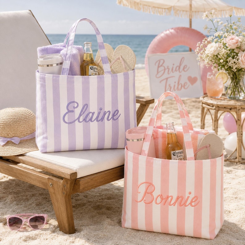 May include: Two striped canvas tote bags, one lavender and white with the name Elaine embroidered in purple, and one pink and white with the name Bonnie embroidered in pink. Each bag contains a towel, a bottle, and a pair of flip-flops.