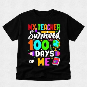 May include: A black short-sleeved t-shirt featuring a colourful graphic with the text "MY TEACHER SURVIVED 100 DAYS OF ME". The design includes school-themed illustrations such as a globe, pencils, a ruler, scissors, and a book in vibrant colours.