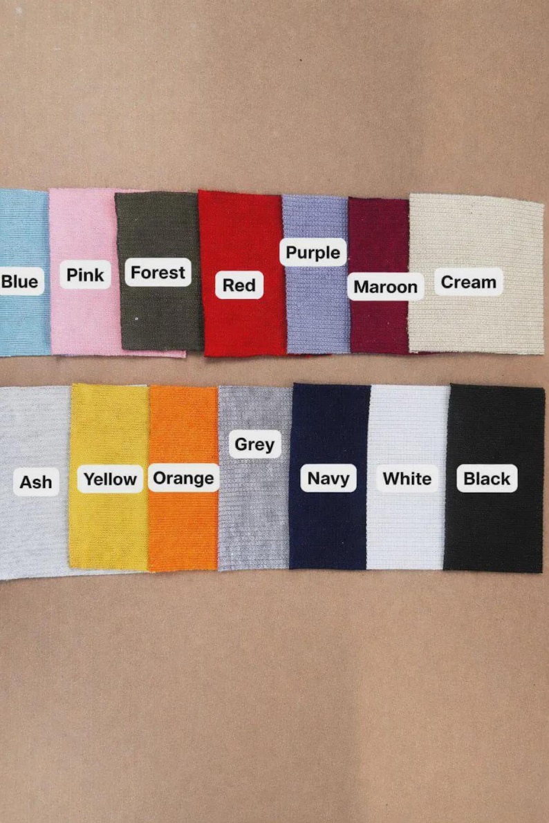 May include: A color palette of fabric swatches in various shades, including blue, pink, forest green, red, purple, maroon, cream, ash, yellow, orange, grey, navy, white, and black. Each swatch is labeled with its corresponding color name.