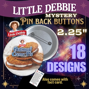May include: Little Debbie mystery pin back buttons measuring 2.25 inches in diameter. The set includes 18 designs featuring an Oatmeal Creme Pie graphic with the Little Debbie logo. Each button has a metal pin back and comes with a small fact card.