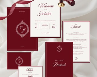 May include: A collection of burgundy wedding stationery, including invitations, RSVP cards, and detail cards. The main invitation features the names "Veronica and Jordan" and event details. A decorative seal and ribbon add to the elegant theme.