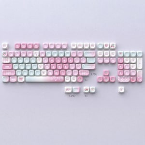 May include: A collection of pastel pink and blue keyboard keycaps, arranged on a light purple surface. The keycaps display letters, numbers, and symbols, with decorative elements such as bows and cherries. These keycaps are designed for a mechanical keyboard, offering a custom aesthetic.