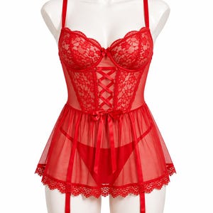 May include: A red lingerie set on a mannequin. The set includes a lace bustier with adjustable straps and a ribbon tie-up front. It also features a matching skirt with lace trim, garter straps, and a thong.