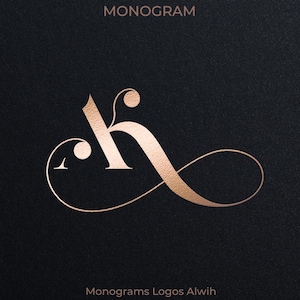 May include: A rose gold monogram design featuring the letters "AK" intertwined with an elegant, flowing script. The design is set against a dark background, with the word "MONOGRAM" at the top and "AK" and "KA" on either side.