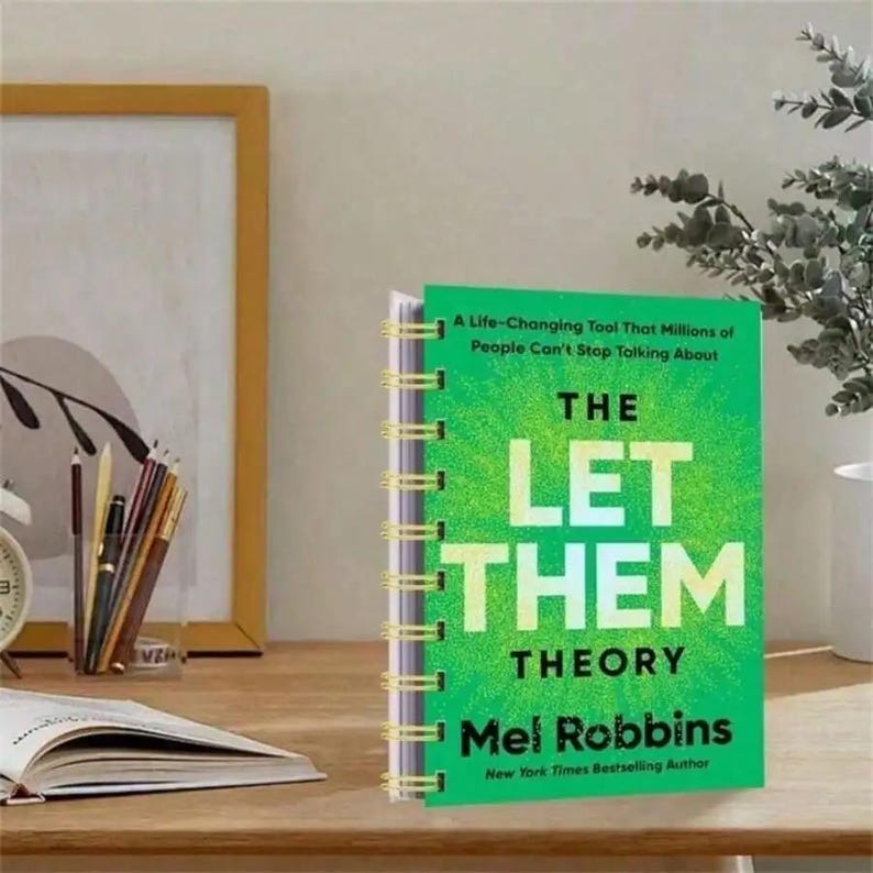 May include: A white ceramic mug with a black handle and the text "But First, Coffee" in a bold, black font. The mug is set against a blurred background, suggesting a cozy setting. The mug appears to be approximately 4 inches tall.