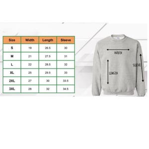May include: A light grey sweatshirt with measurements for width, length, and sleeve length. A size chart shows measurements in inches for sizes S, M, L, XL, 2XL, and 3XL. The sweatshirt has a crew neck.