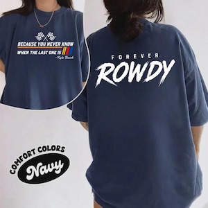 May include: Navy blue Comfort Colors t-shirt with the text "BECAUSE YOU NEVER KNOW WHEN THE LAST ONE IS - Kyle Busch" on the front. The back of the shirt features the word "FOREVER ROWDY" in white. The shirt has short sleeves.