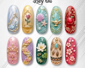 May include: A set of ten intricately designed nail art creations. Each nail features a unique design, including a Cinderella slipper, a rose in a glass dome, a seashell, a genie's lamp, and an apple. The nails are adorned with various colors and embellishments.