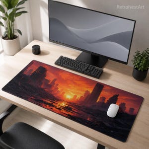 May include: A rectangular desk mouse pad featuring a dystopian city scene under a fiery sunset. The artwork depicts ruined buildings and a vibrant orange and red sky. A computer mouse, keyboard, and monitor are on the desk.