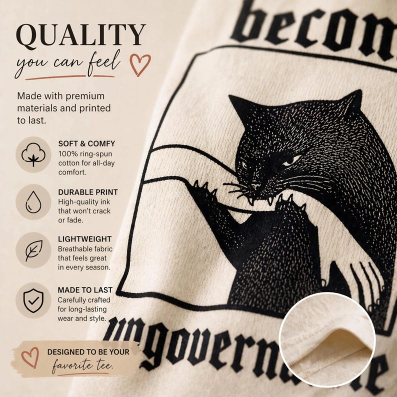 May include: Cream-colored t-shirt with a black graphic of a cat and the word "becon" at the top. The text "QUALITY you can feel" is at the top left. The shirt is made of soft, ring-spun cotton.
