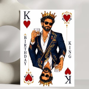 May include: A rectangular playing card featuring a bearded figure wearing a gold crown, sunglasses, and a navy blue suit with gold embroidery. The figure holds a glass of amber liquid in each hand. The text BIRTHDAY KING is printed vertically.