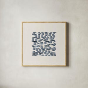 May include: Abstract art print in a natural wood frame. The artwork features a geometric design of overlapping, three-dimensional shapes in shades of blue-gray against a cream background. The square frame adds a modern touch to the piece.