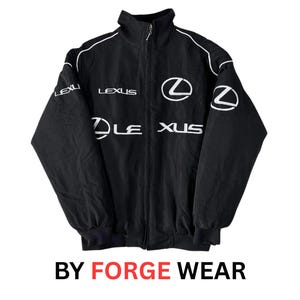 May include: Black zip-up jacket with white detailing and the Lexus logo. The jacket has the Lexus name in white across the chest and sleeves. The text "BY FORGE WEAR" is at the bottom.