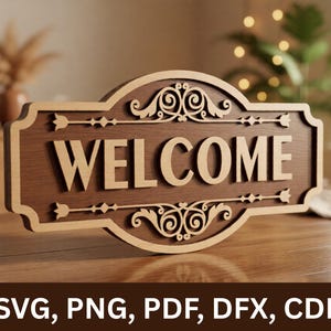 May include: A wooden welcome sign with a decorative border and the word "WELCOME" in large, raised letters. The sign is brown with a lighter wood trim and ornate scrollwork. The sign is on a wooden table.
