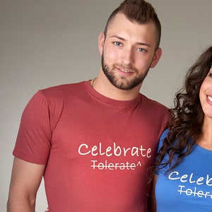 May include: Three people wearing t-shirts with the text "Celebrate Tolerate" in white lettering. The person on the left is wearing a red t-shirt, the person in the middle is wearing a blue t-shirt, and the person on the right is wearing a green t-shirt.