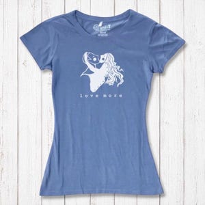 Sky blue bamboo & organic cotton Love More T-Shirt for women with white heart graphic. Sustainable and romantic fashion statement.