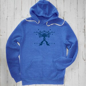 May include: A blue heather hoodie with a dark blue graphic of a tree with the text "dream more" underneath.